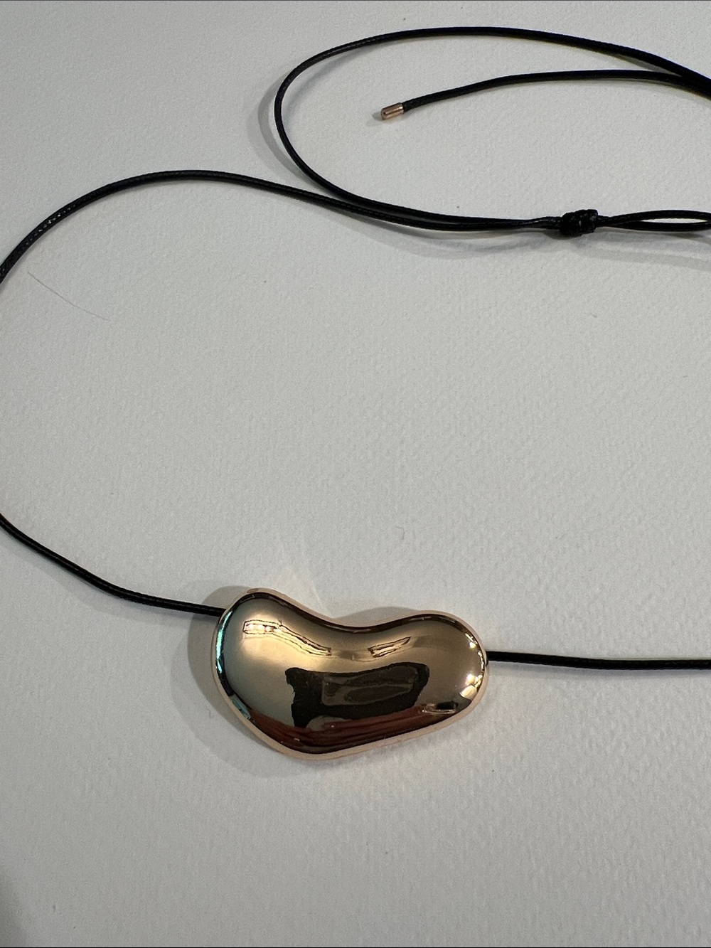 Adrienne Vittadini Polished Gold Bean Pendant on Black Cord